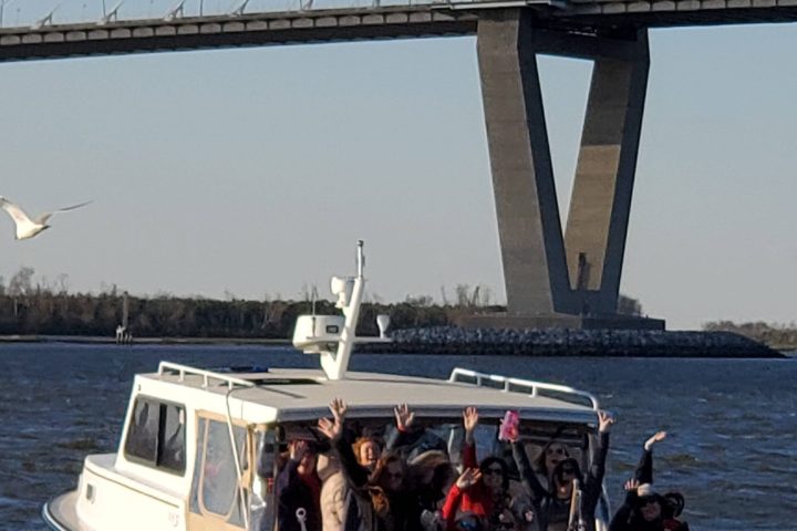 a group of people in a boat on a body of water