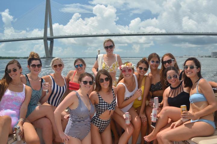 a group of people sitting in front of a body of water