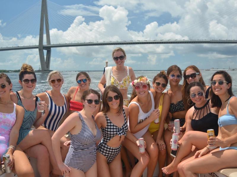 a group of people sitting in front of a body of water