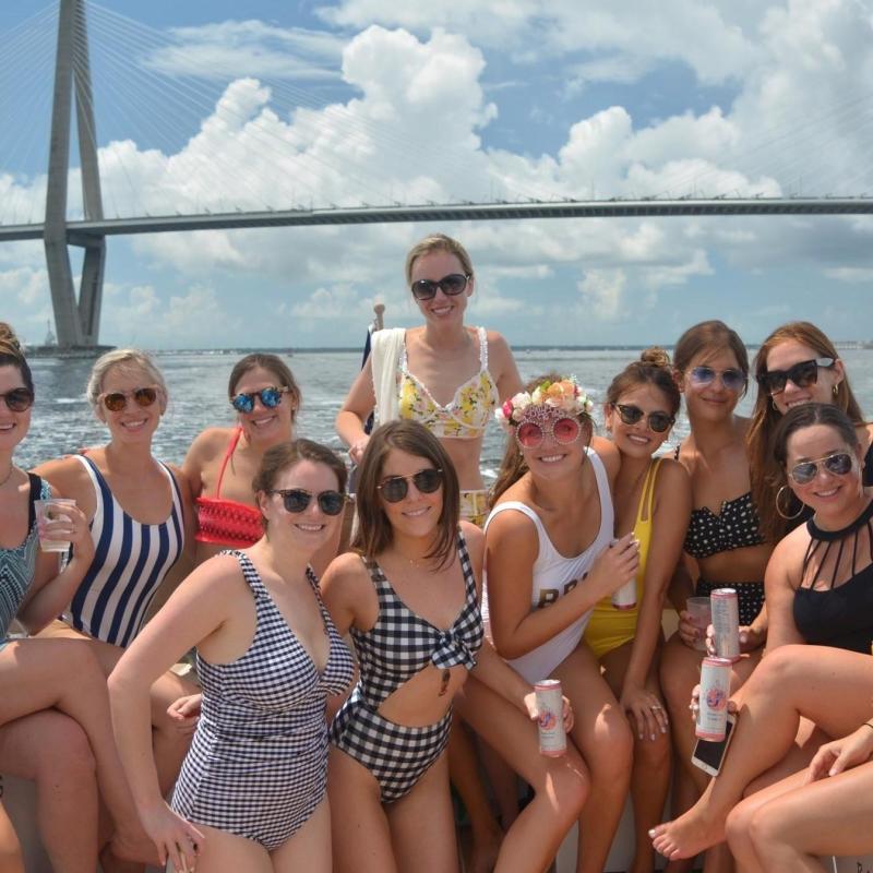 a group of people sitting in front of a body of water