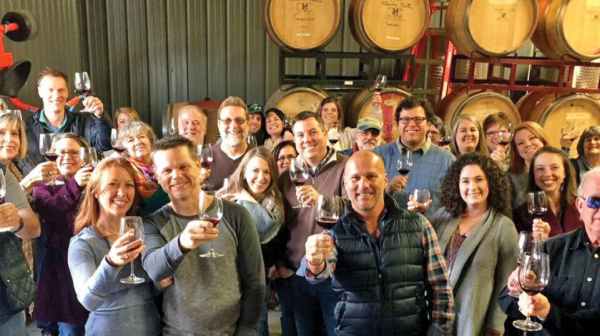 Brian Haner et al. holding wine glasses