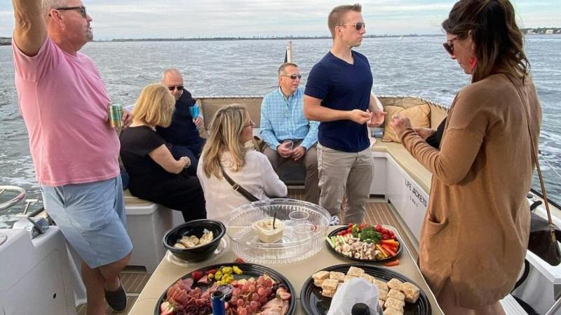 a group of people sitting at a table with food