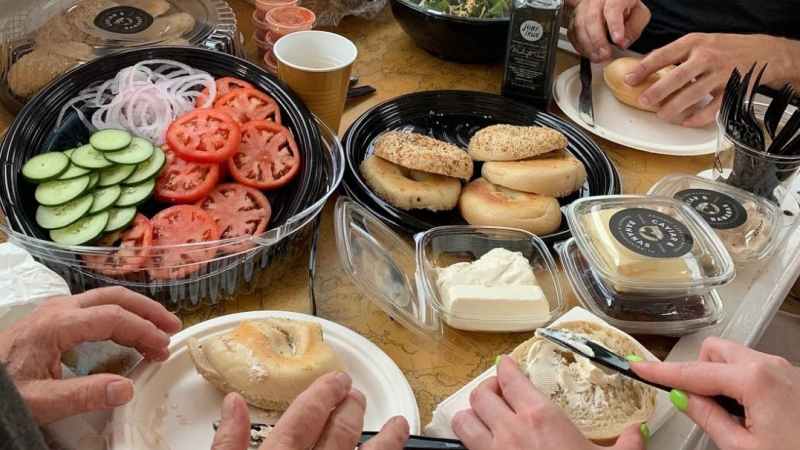 a group of people sitting at a table with a plate of food