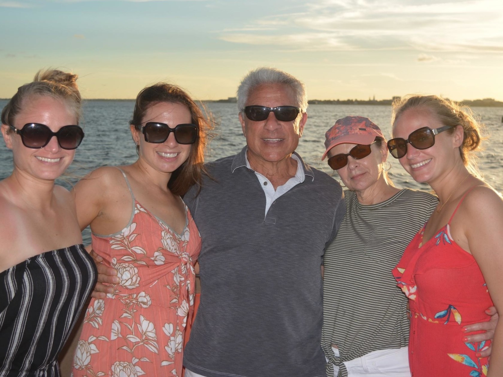 a group of people standing next to a body of water