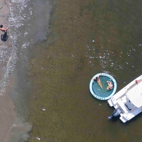 a man standing next to a body of water