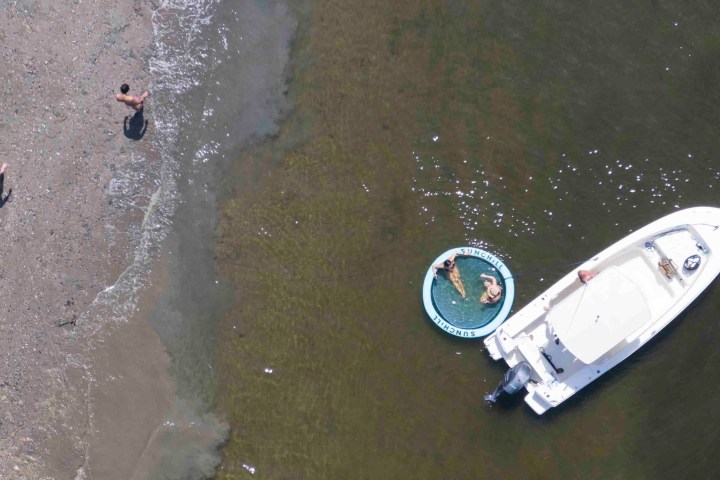 a man standing next to a body of water