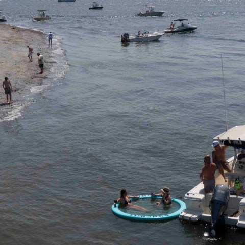 a group of people in a boat on a body of water