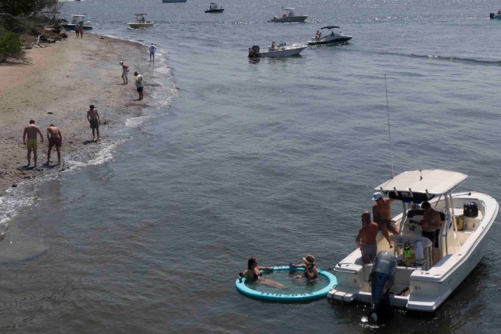 a group of people in a boat on a body of water