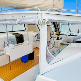 Interior view of a yacht cockpit with plush seating and a steering area.